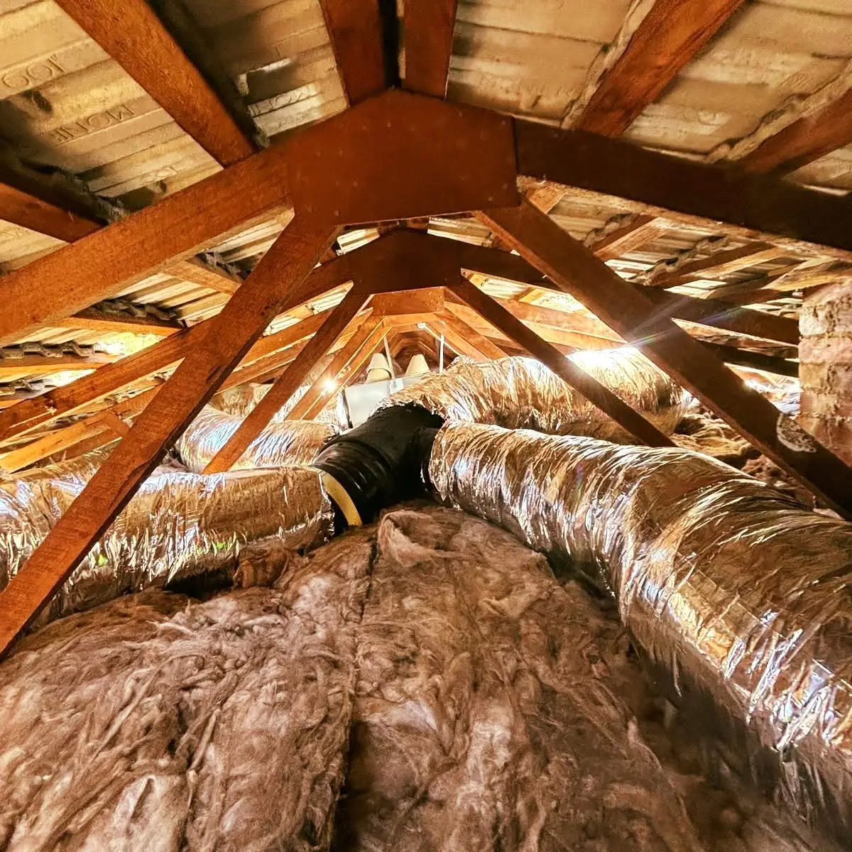 Roof space with ducting and new insulation batts