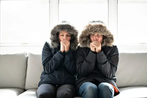 Image: Two people inside a cold home in Canberra